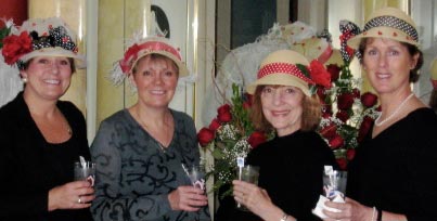 four ladies in derby hats, drinking mint juleps