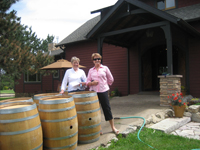 carol and barb by the wine barrels