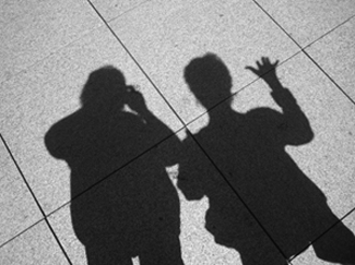 shadows of meredith and barb on the sidewalk